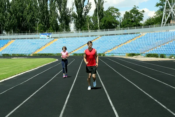 Young people jogging on stadium — Stock Photo, Image