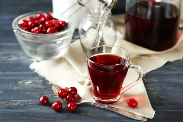 Sweet homemade cherry juice on table, on color wooden background — Stock Photo, Image