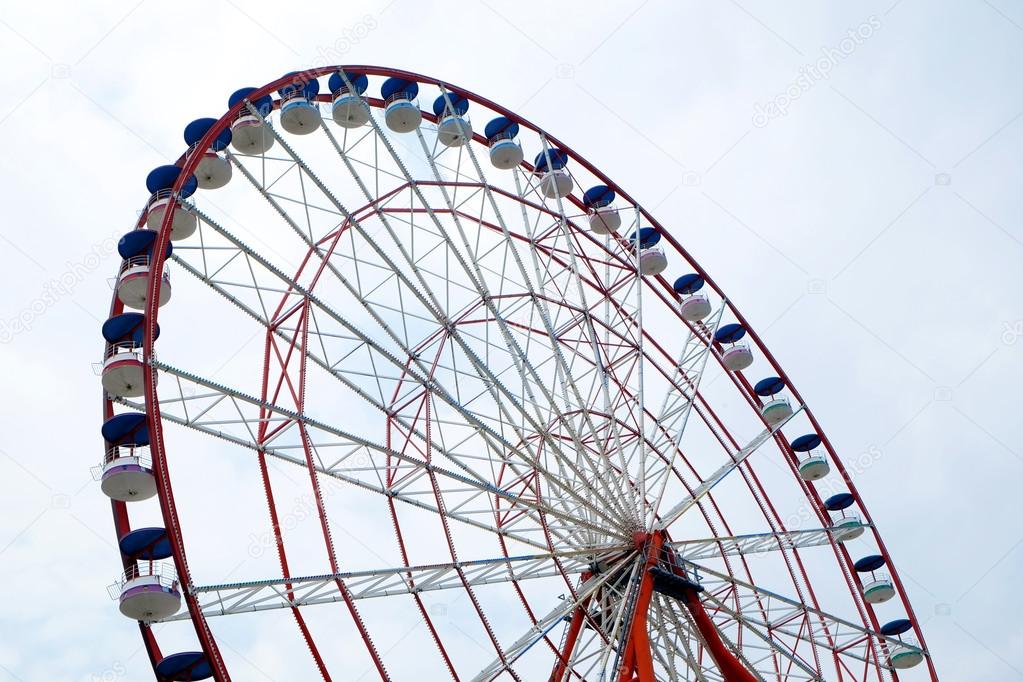 Ferris wheel on blue sky background