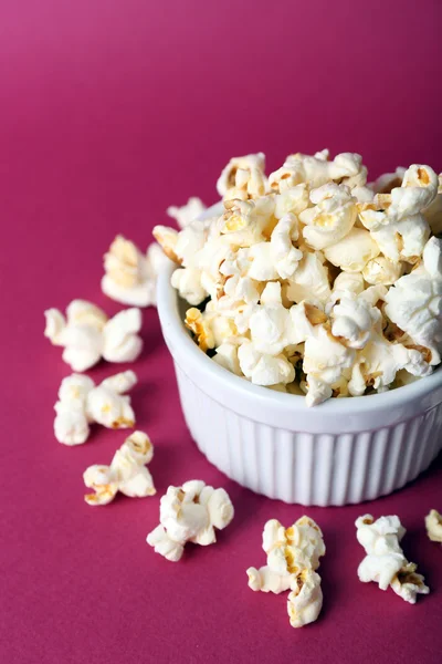 Salted popcorn on pink background — Stock Photo, Image