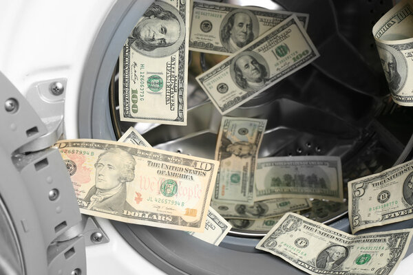 Dirty money in washing machine, close up