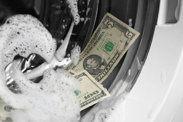 Laundering of dirty money in washing machine, close up — Stock Photo, Image