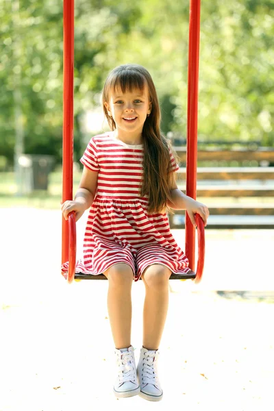 Little girl on swing in the park — Stock Photo, Image