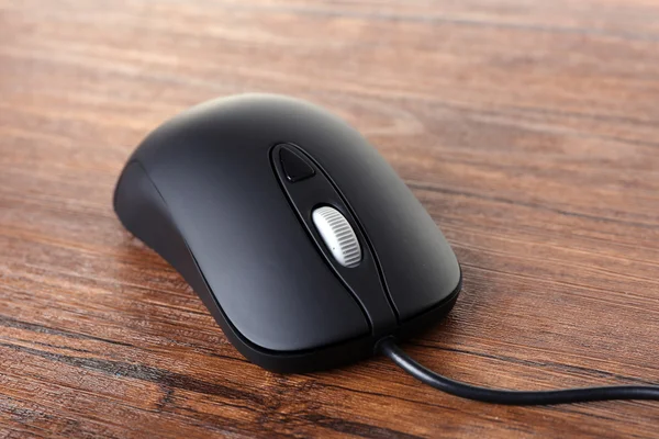 Computer mouse with cord on wooden background — Stock Photo, Image