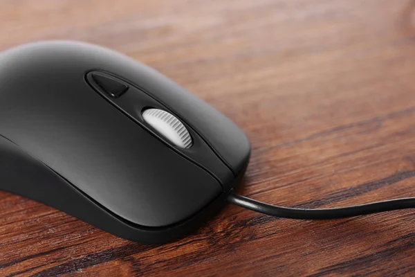 Computer mouse with cord on wooden background — Stock Photo, Image