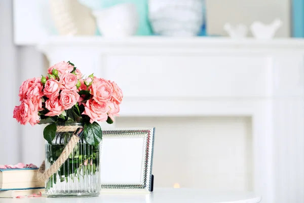 Прекрасна троянда у вазі на столі в кімнаті — стокове фото
