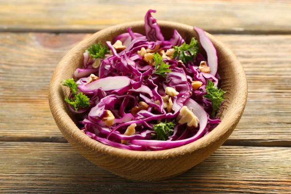 Red cabbage and parsley salad in bowl on wooden table — Stock Photo, Image