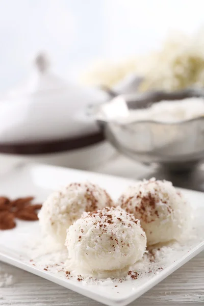 Homemade coco sweets on plate, on light background — Stock Photo, Image