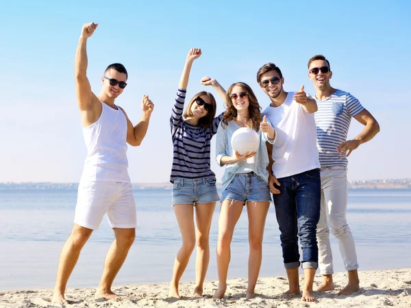 Young people playing with ball on the riverside — Stock Photo, Image