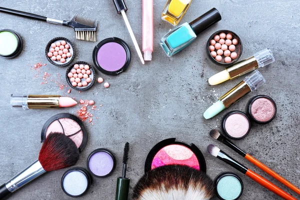 Decorative cosmetics laying out as a frame on grey background — Stock Photo, Image