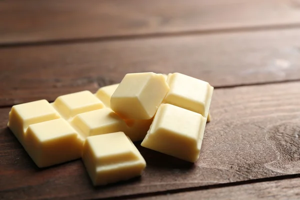 White chocolate pieces on wooden background — Stock Photo, Image