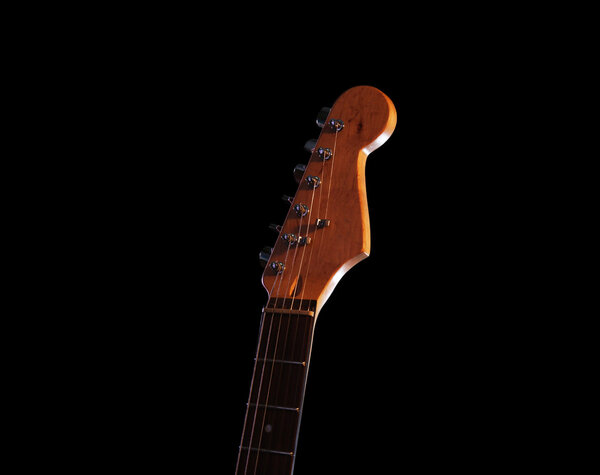 Guitar's fingerboard on dark background, close up