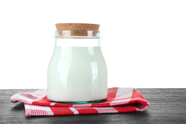 Glass jar of milk on wooden table — Stock Photo, Image