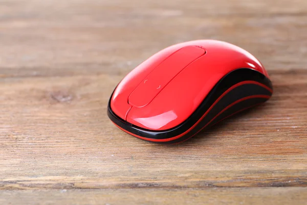 Wireless computer mouse on wooden background