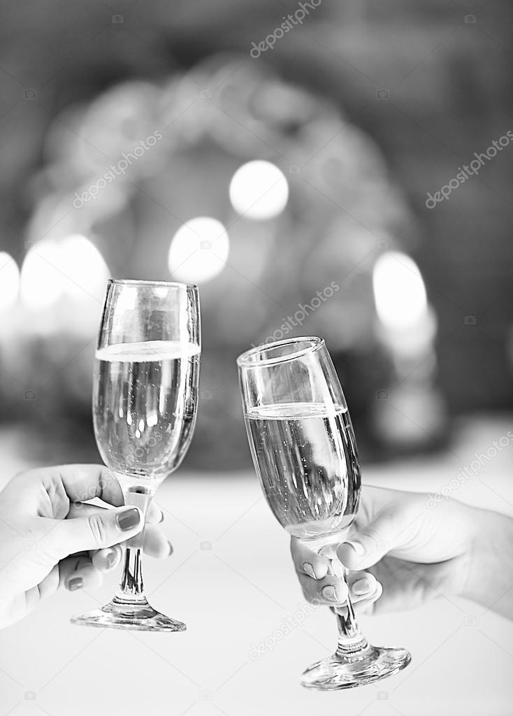 glasses of champagne in hands