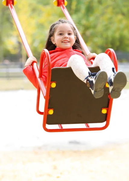 Little girl on swing in park — Stock Photo, Image