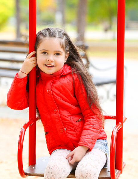 Little girl on swing in park