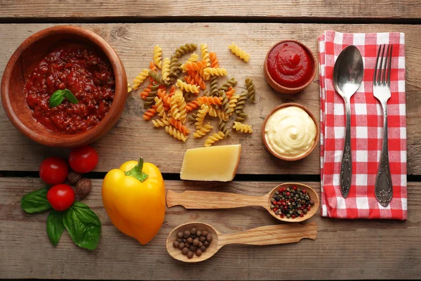 Penne de pasta con tomates, salsa boloñesa, queso y albahaca sobre fondo rústico de madera —  Fotos de Stock