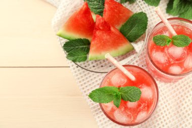 Soğuk karpuz tatlılar ve içecekler içinde gözlük, ahşap masa arka plan üzerinde