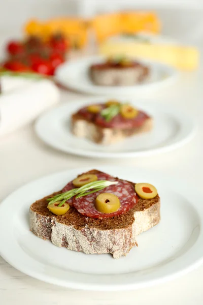 Tasty sandwiches on plates, close up — Stock Photo, Image