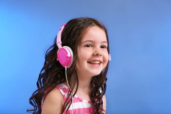 Attractive little girl with pink headphones — Stock Photo, Image