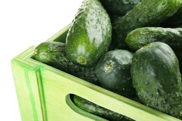 Ripe cucumbers in wooden box isolated on white — Stock Photo, Image