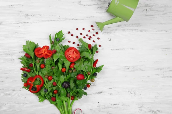 Cute bouquet of parsley and dill decorated with tomatoes, pepper and berries on light wooden background — Stock Photo, Image