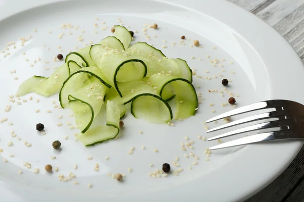 Sliced cucumbers dish on white plate in the restaurant, close up — Stock Photo, Image