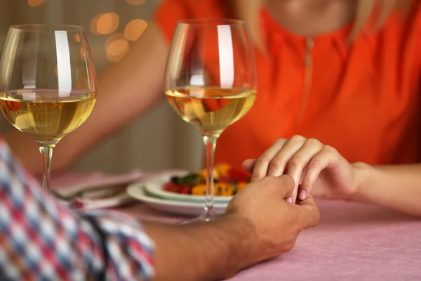 Woman holding male hand in restaurant — Stock Photo, Image