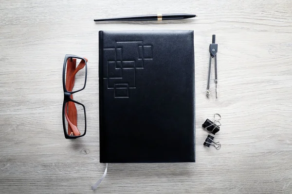 Black notebook and stationery — Stock Photo, Image