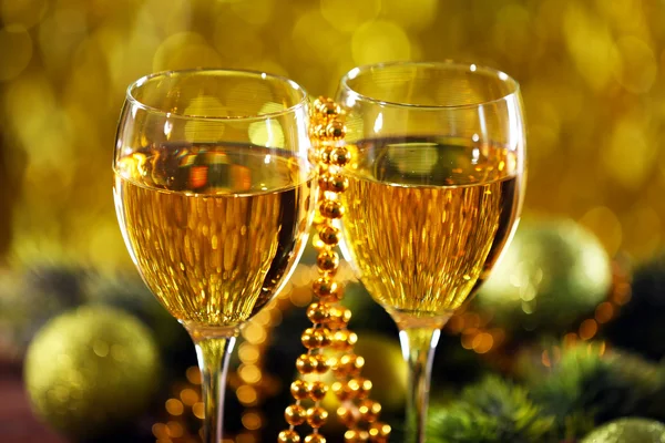 Champagne and Christmas decoration on bright background — Stock Photo, Image