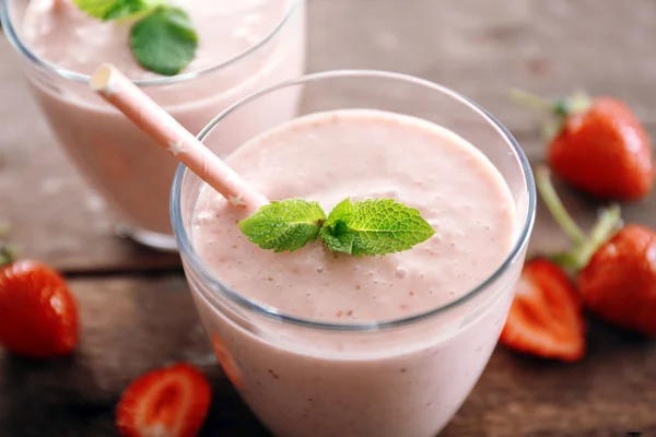 Fresh strawberry yogurt with berries around on wooden background — Stock Photo, Image