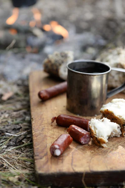 Sausages on fire in wood — Stock Photo, Image