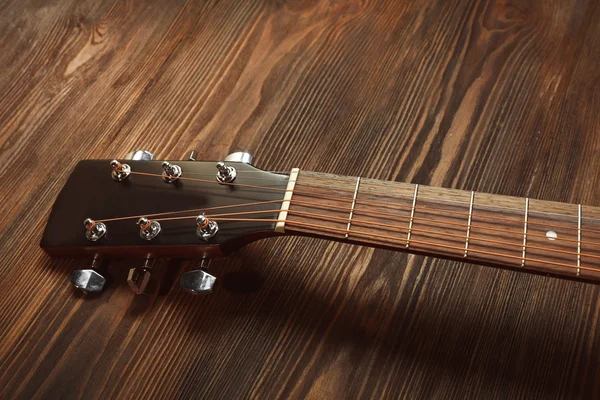 Guitar handle on wooden background — Stock Photo, Image