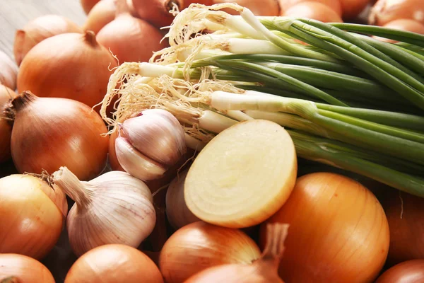 Cebollas frescas diferentes y fondo de ajo — Foto de Stock