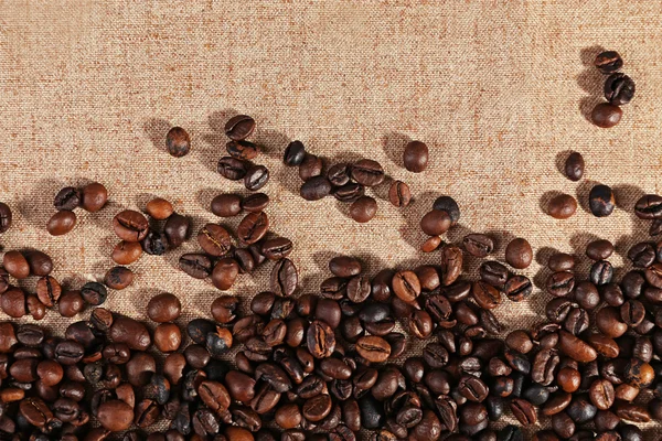 Roasted coffee beans on the linen fabric — Stock Photo, Image