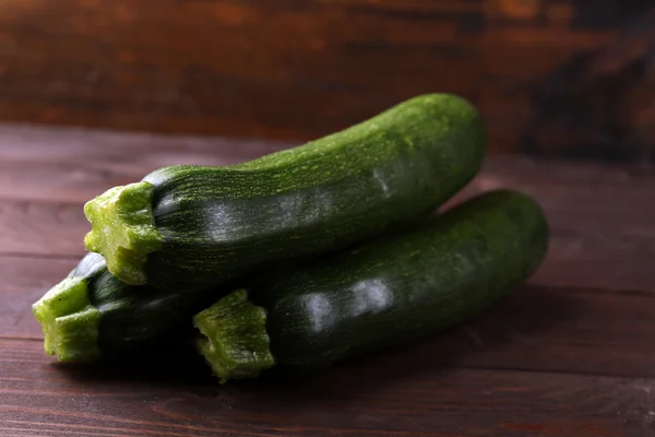 Fresh zucchini on wooden background — Stock Photo, Image