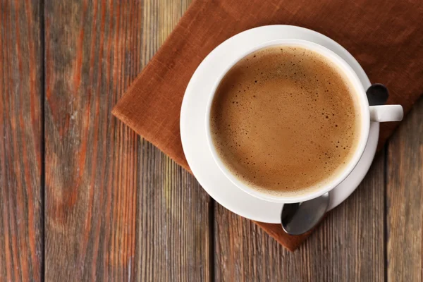 Cup of coffee on brown napkin closeup — Stock Photo, Image