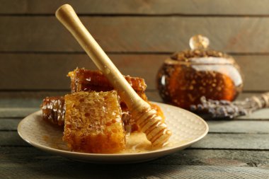 Peteğin ve ahşap arka plan üzerinde plaka üzerinde ahşap Kepçe