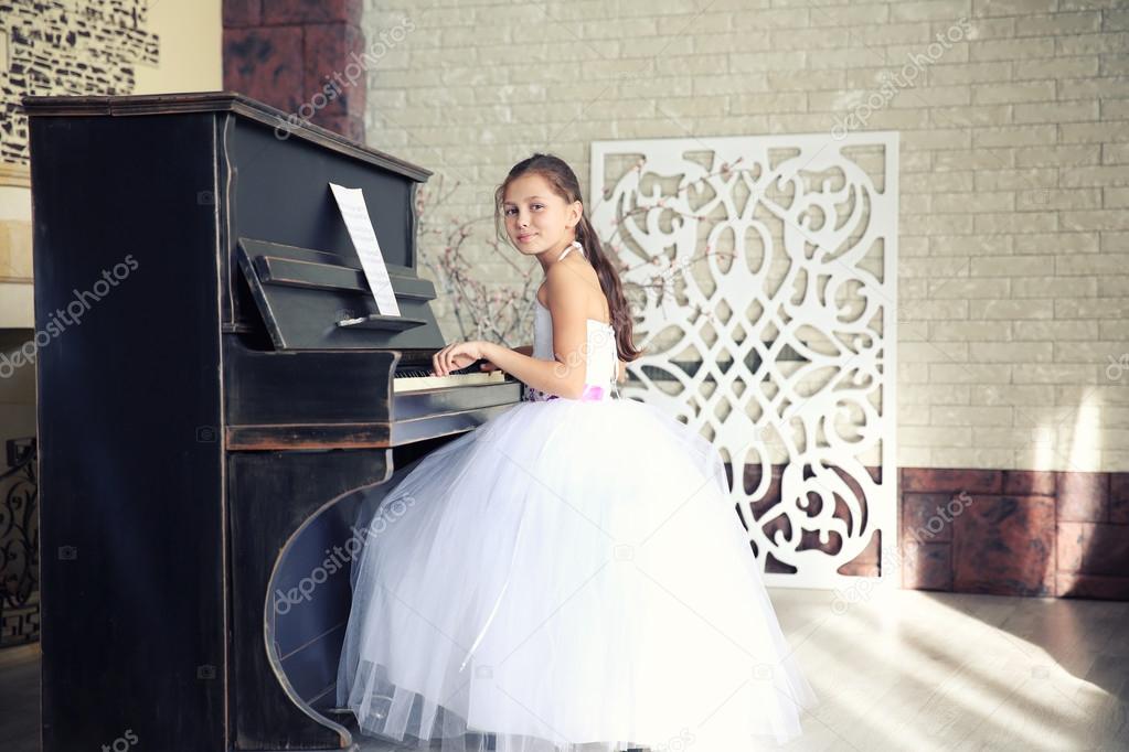 Beautiful girl playing on piano 