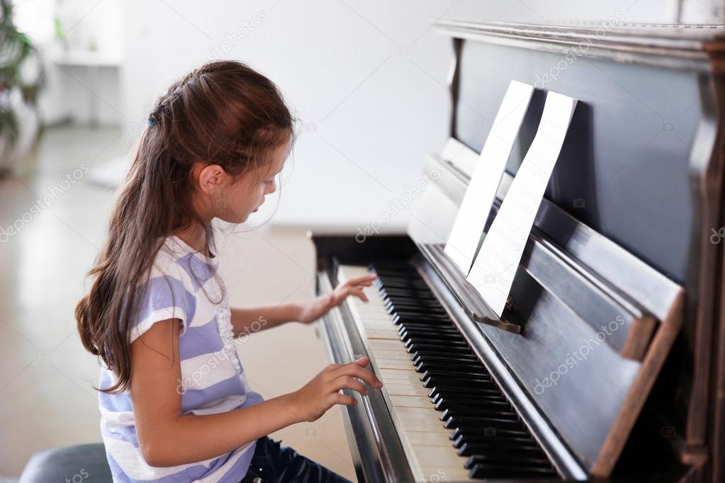girl studding to play piano
