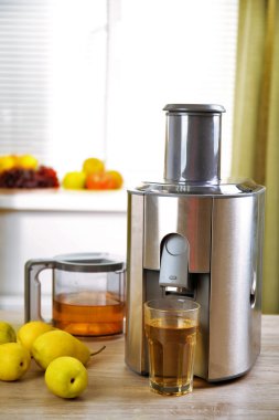 Mutfak masasının üzerinde meyve sıkacağı ve armut suyu