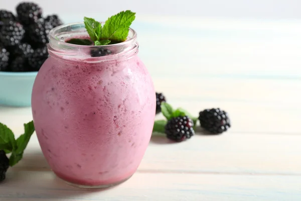 Delicious berry smoothie with blackberries on wooden table close up — Stock Photo, Image