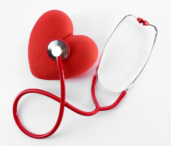 Red stethoscope with heart isolated on white — Stock Photo, Image