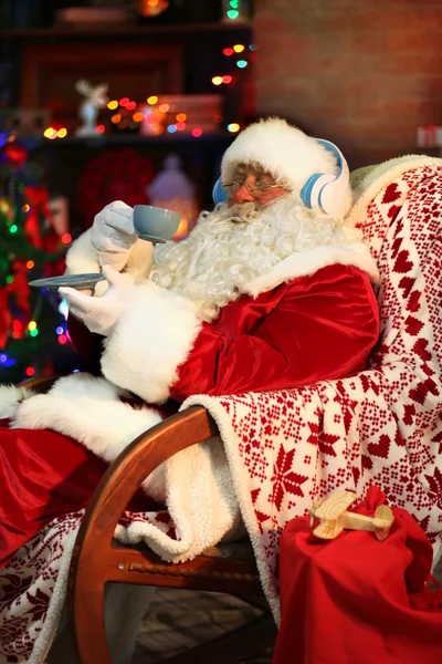 Santa Claus sitting with headphones — Stock Photo, Image