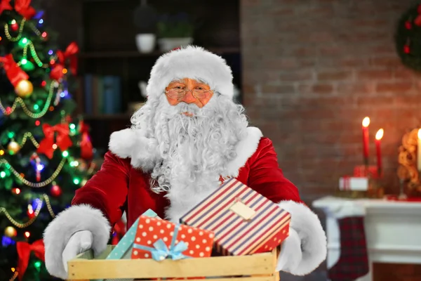 Santa holding gift — Stock Photo, Image