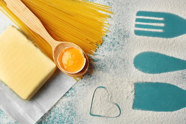 Heart of flour and pasta on color wooden background — Stock Photo, Image