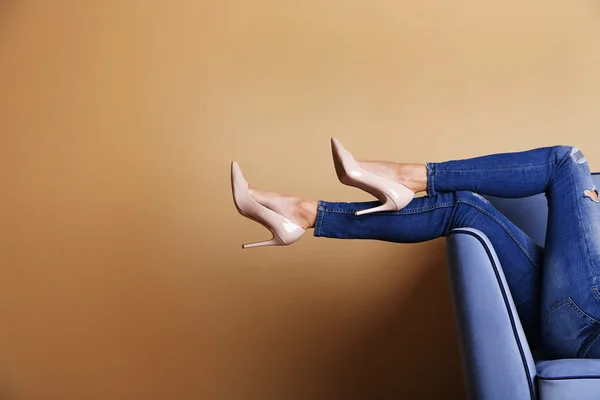 Woman legs on sofa — Stock Photo, Image