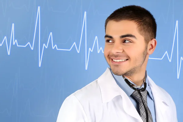 Male doctor with stethoscope and cardiogram — Stock Photo, Image