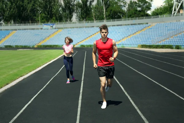 Jóvenes corriendo en el estadio — Foto de Stock